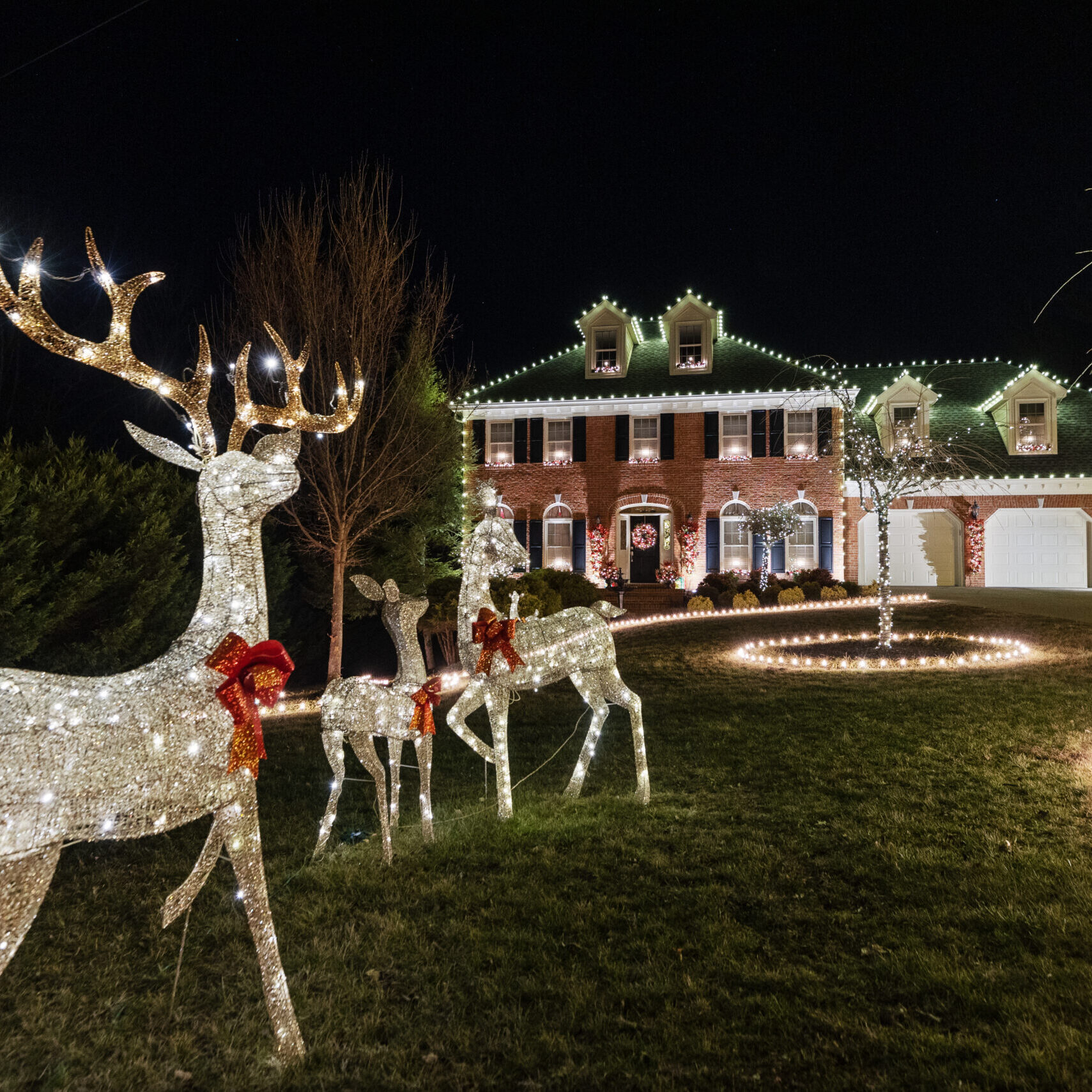 The lively house is embellished with a kaleidoscope of colorful Christmas lights, emanating a jubilant and joyful ambiance.