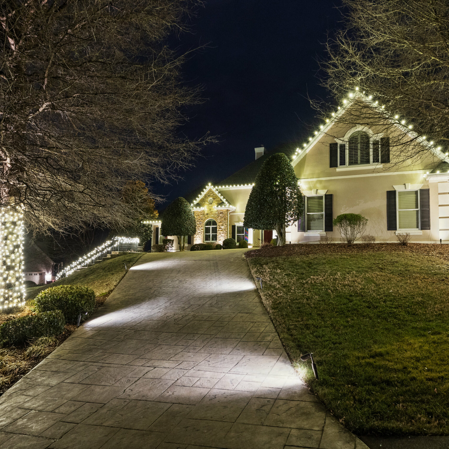 On Christmas night, the house is aglow with festive lights, creating a warm and joyous atmosphere.