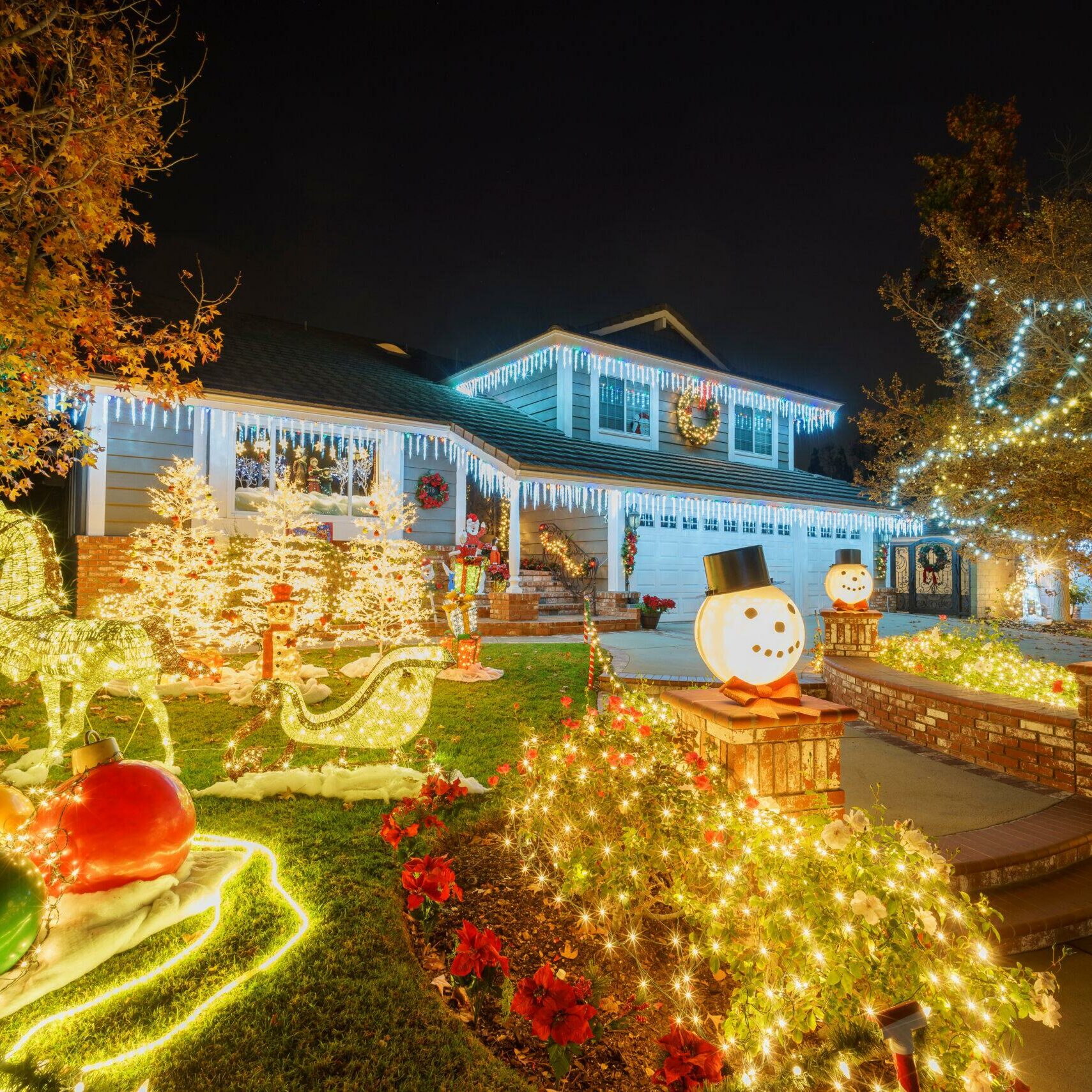 A house adorned with twinkling Christmas lights, spreading holiday cheer and creating a warm and inviting ambiance.